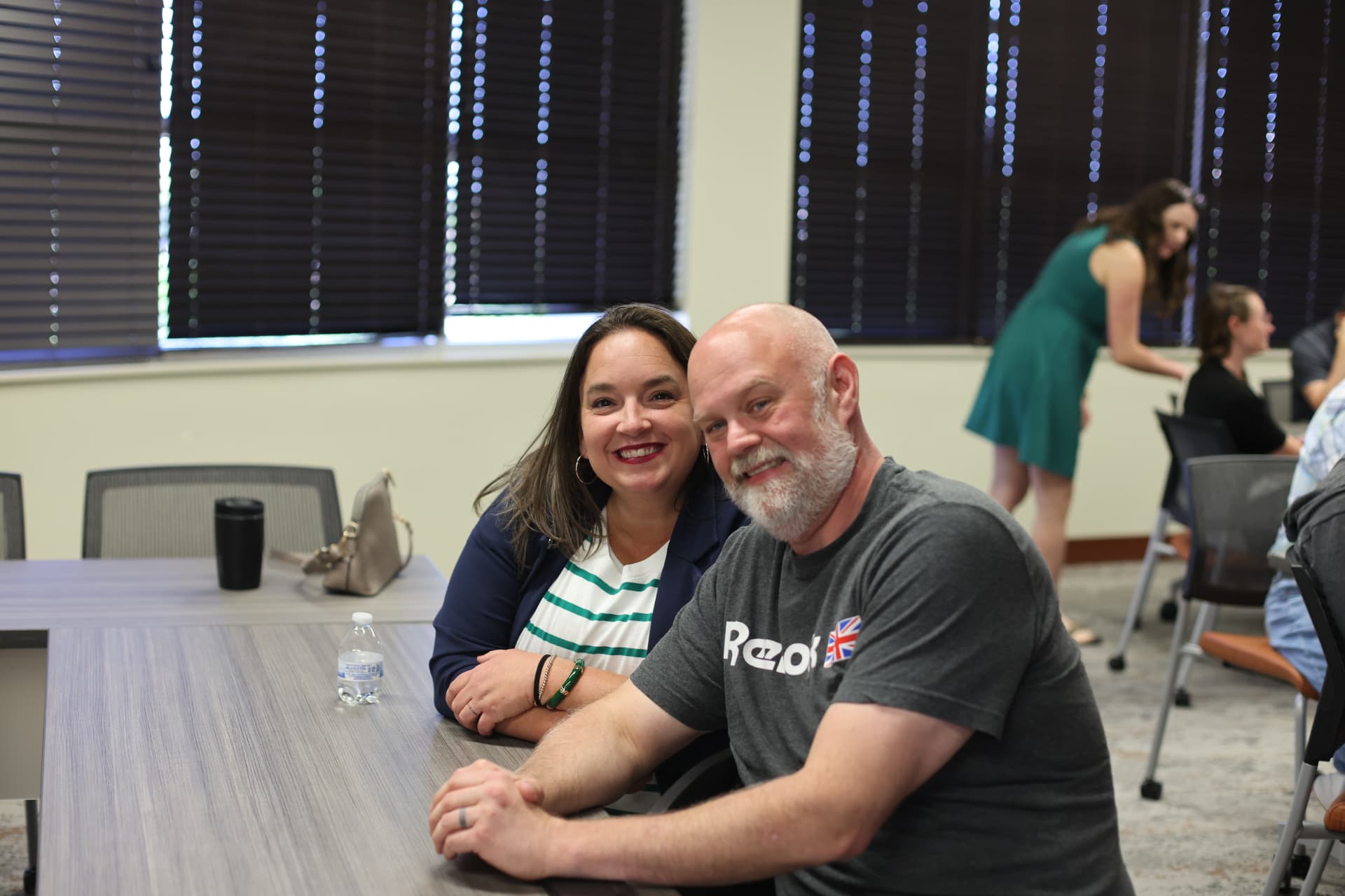 Two friends smiling together at an AI in Fort Wayne meetup